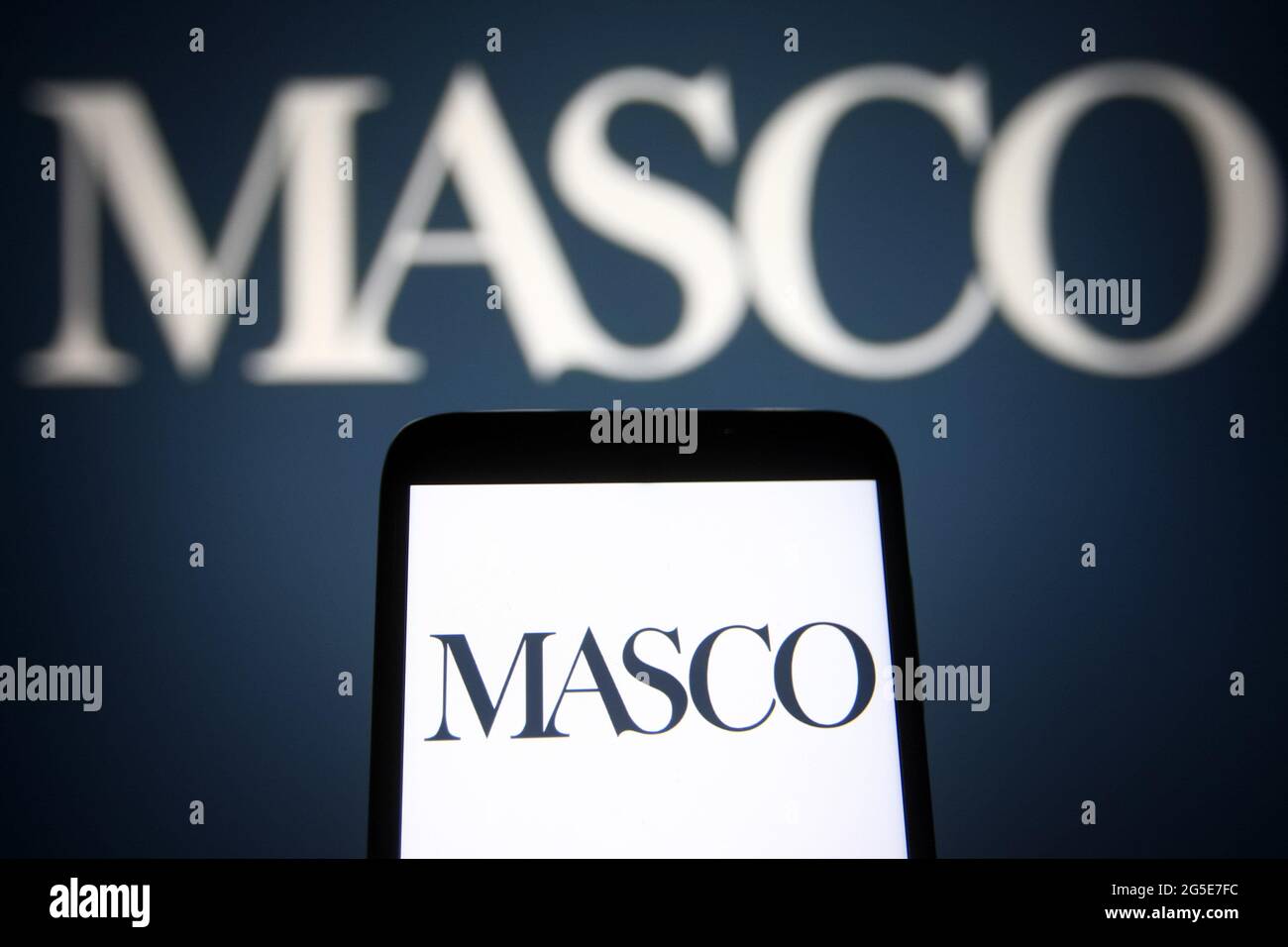 Dans cette illustration, un logo Masco Corporation apparaît sur un smartphone et un écran de pc. Banque D'Images
