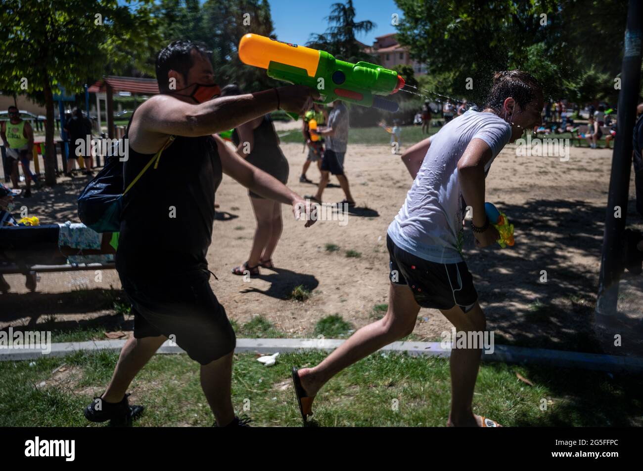 Madrid, Espagne. 27 juin 2021. Les personnes jouant avec des armes à l'eau comme elles prennent part à un combat d'eau d'été dans le quartier de Vicalvaro à Madrid. Credit: Marcos del Mazo/Alay Live News Banque D'Images