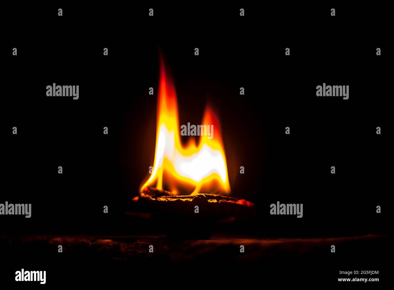 Gros plan de Diva ou divida en feu, de Diya ou de lampe à huile isolée dans l'obscurité. Banque D'Images