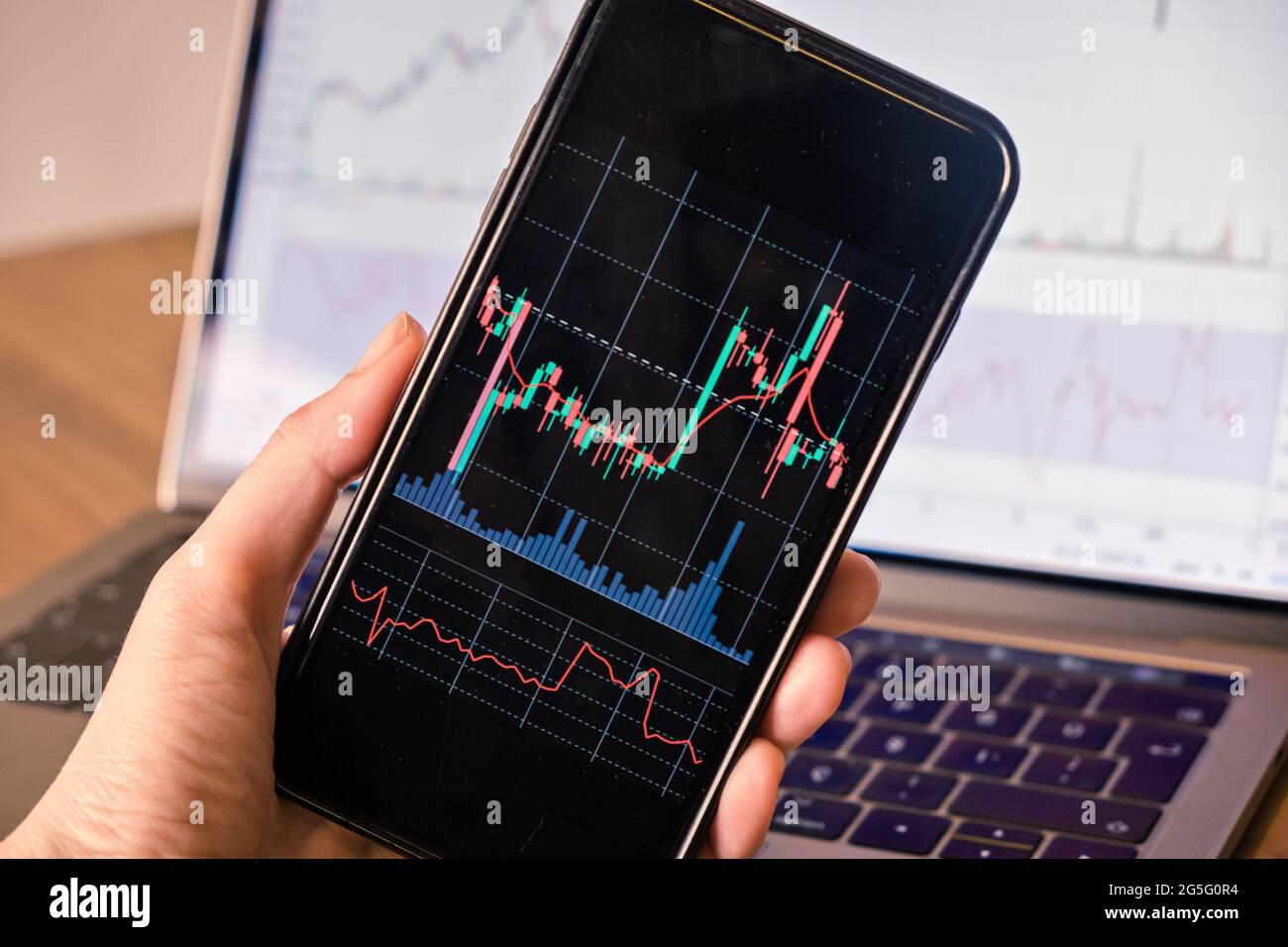 Gros plan et main tenant un smartphone avec un graphique à bougie pour l'investissement de bourse de commerce crypto-monnaie Banque D'Images