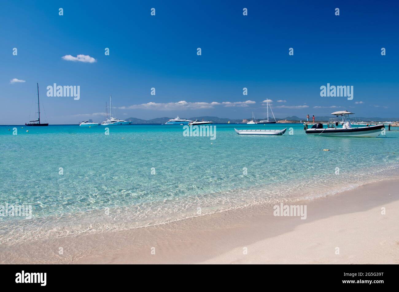 Plage de ses Illetes sur l'île de Formentera, Espagne. En arrière-plan les bateaux ancrés et le ciel bleu Banque D'Images