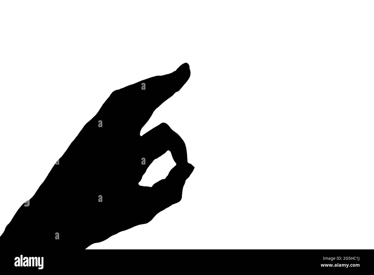 Silhouette ou ombre noire de la main montrant un cercle avec deux doigts ou le signe ok isolé sur fond blanc, gros plan, espace de copie Banque D'Images