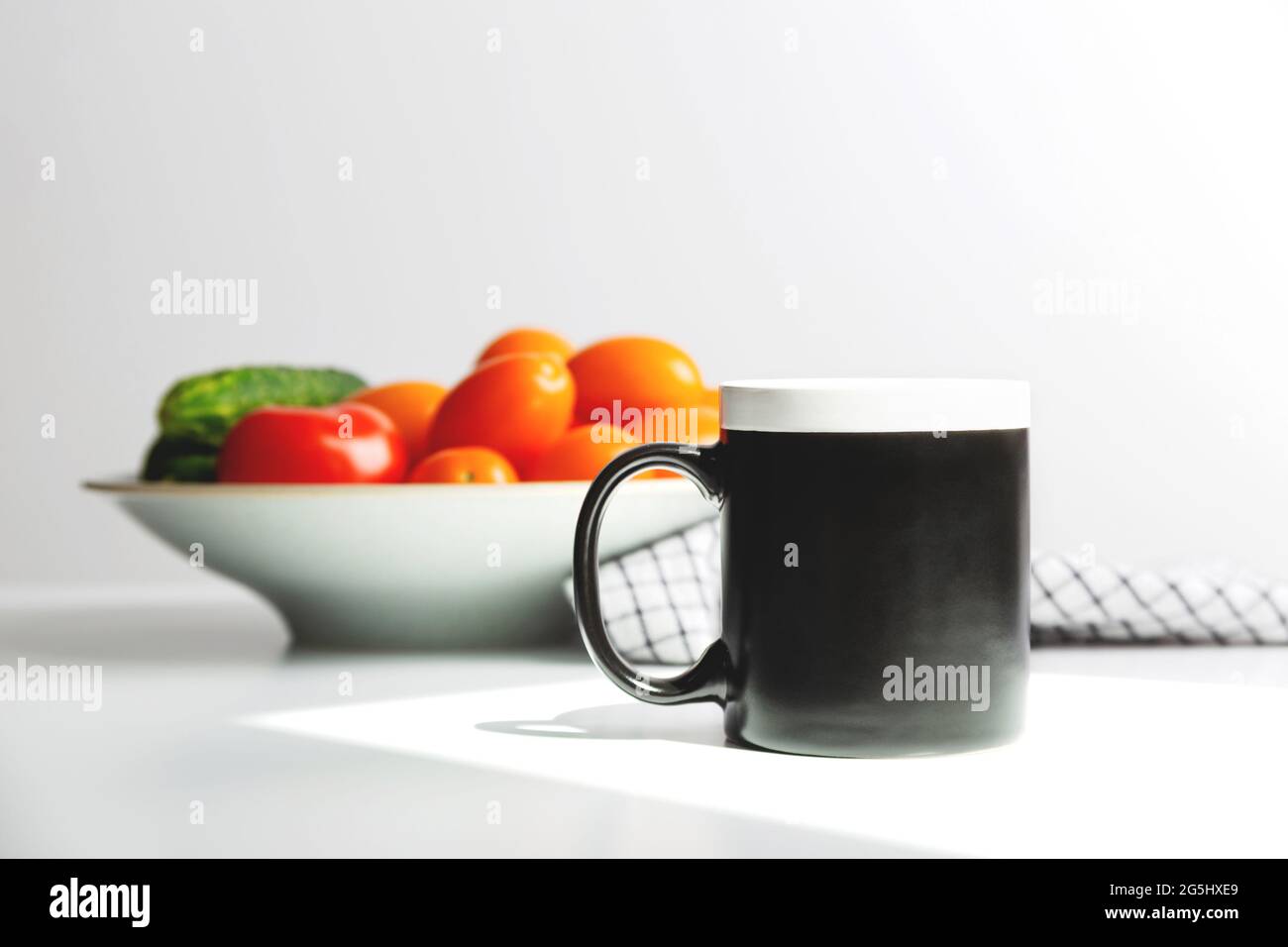 Tasse à café noire maquette sur table de cuisine. Modèle de tasse pour plus de style Banque D'Images