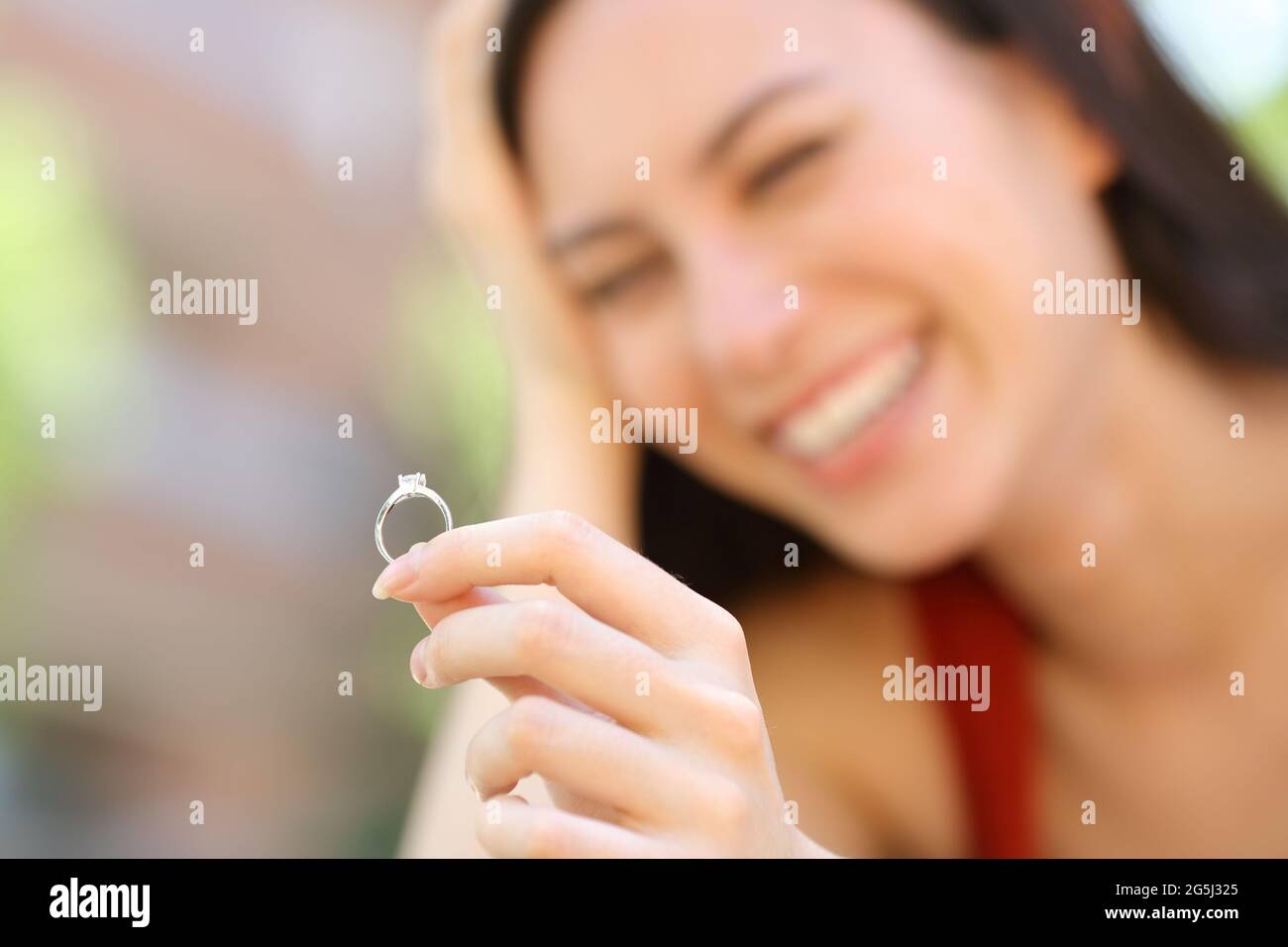Bonne femme asiatique regardant l'anneau d'engagement dans la rue Banque D'Images
