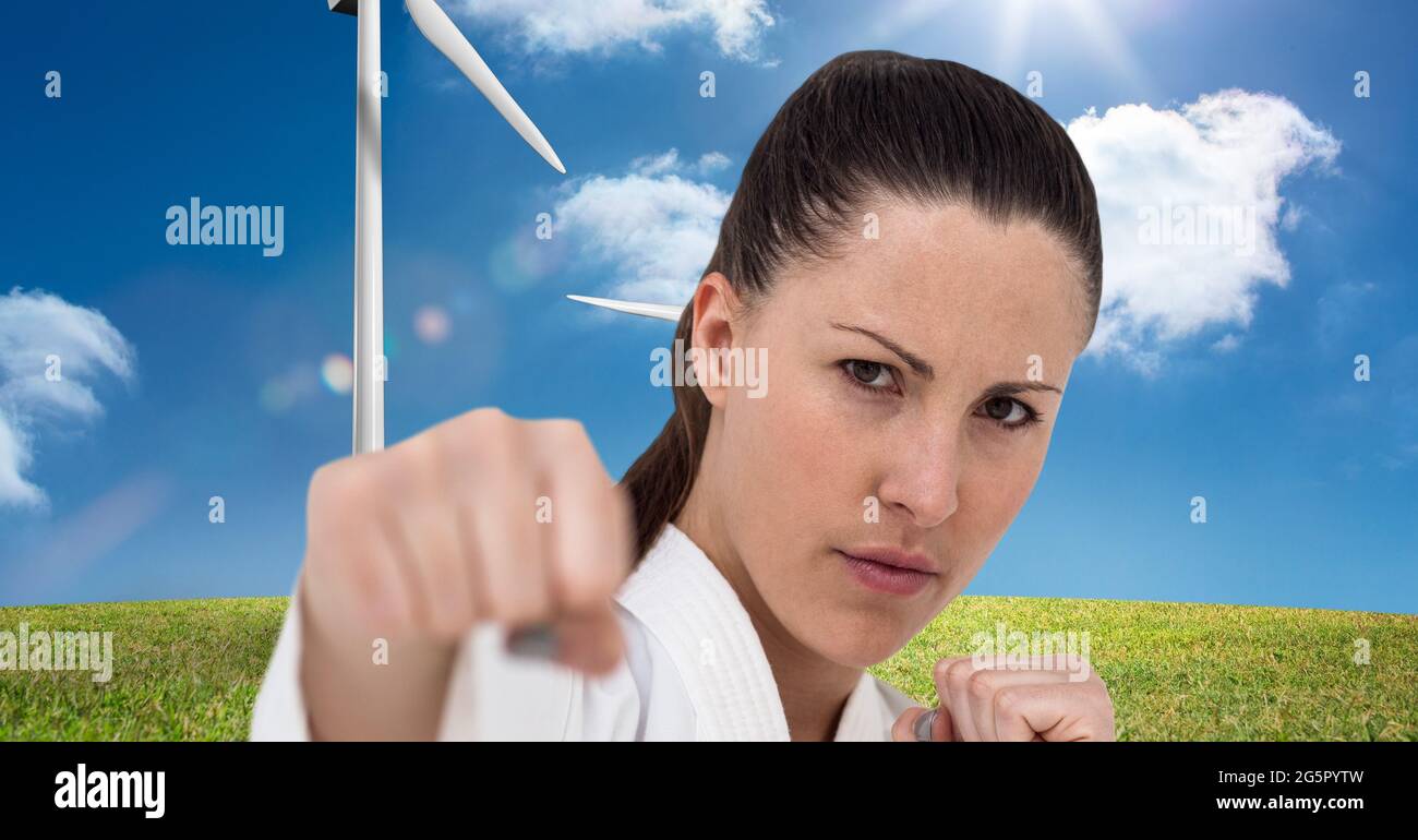 Image numérique composite du portrait d'une femme mariteuse caucasienne contre des éoliennes Banque D'Images