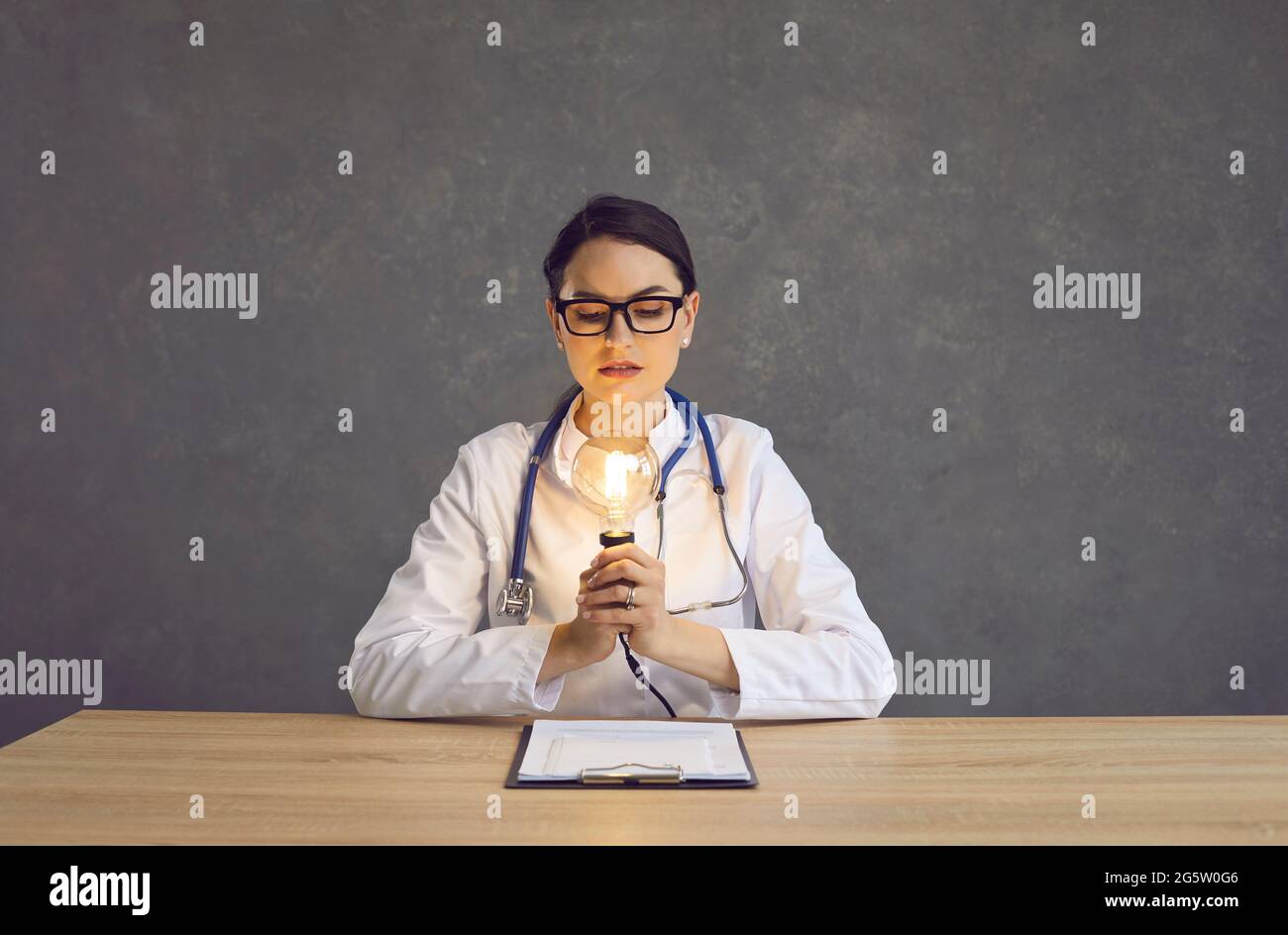 Portrait d'une femme médecin regardant le cliché de studio lumineux IDEA Banque D'Images