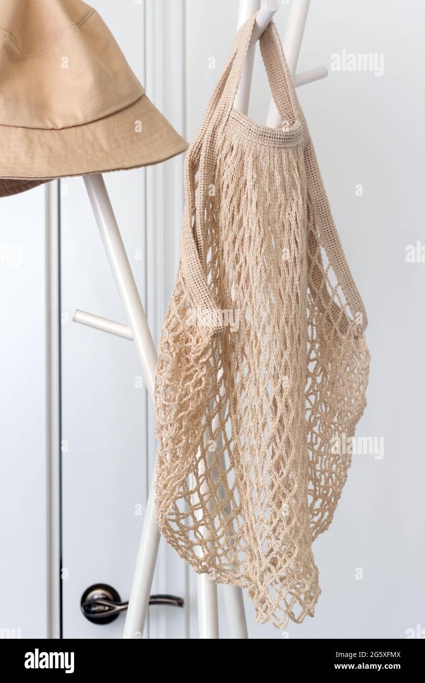 Sac fourre-tout d'épicerie en coton à filet réutilisable accroché à un porte-vêtements. Banque D'Images