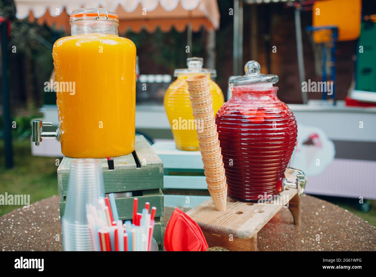 jus de fruits dans de grandes bouteilles sur la table à l'extérieur. Banque D'Images