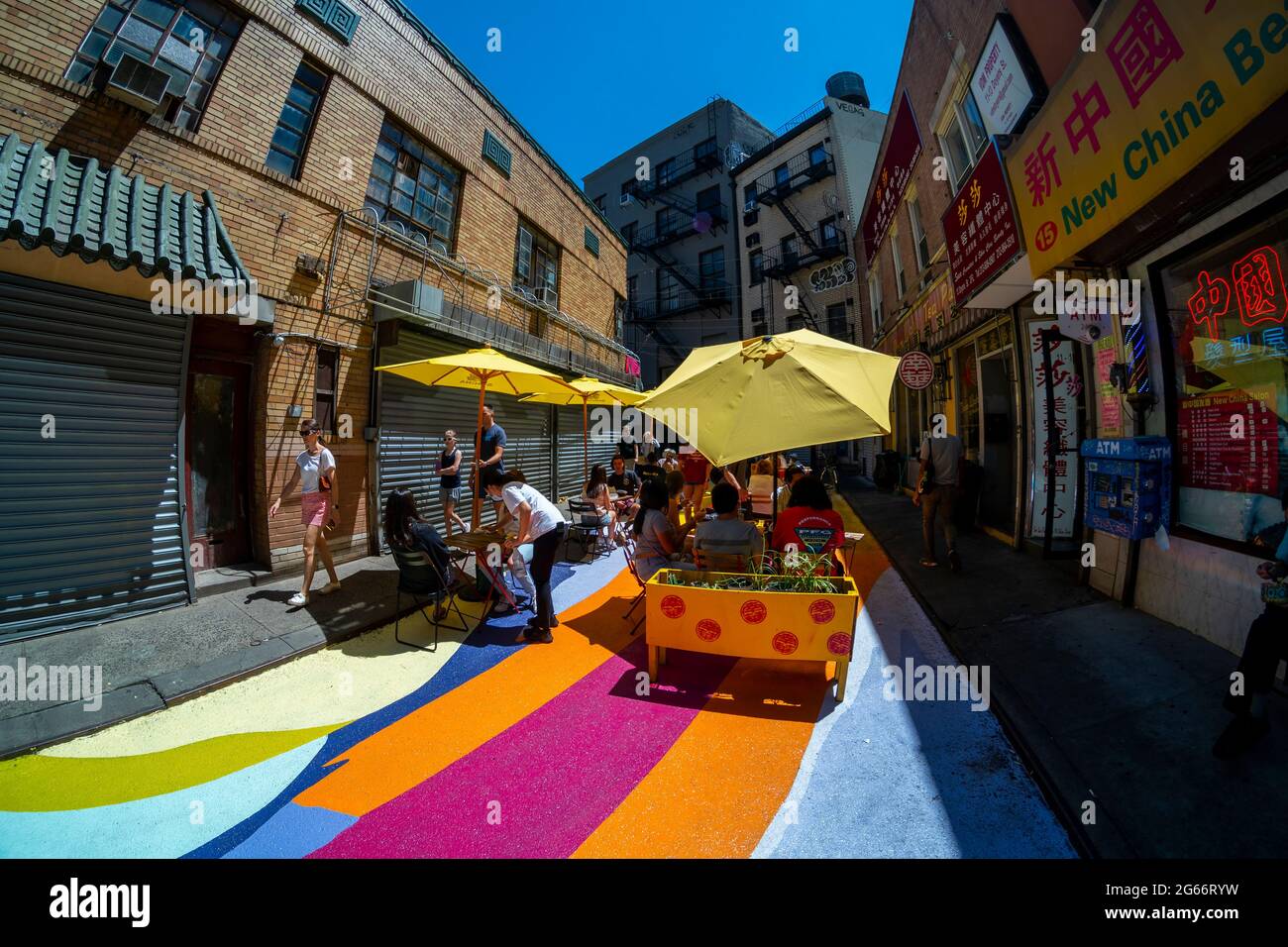 Les visiteurs de la rue Doyers à Chinatown à New York le jeudi 24 juin 2021 apprécient les « terrasses de riz » de Dasic Fernández dans le cadre du programme d'activités artistiques d'Asphalt. L'œuvre d'art de 4851 mètres carrés fait partie des efforts du Chinatown Partnership pour transformer la rue étroite et pittoresque en un centre commercial piétonnier. (© Richard B. Levine) Banque D'Images