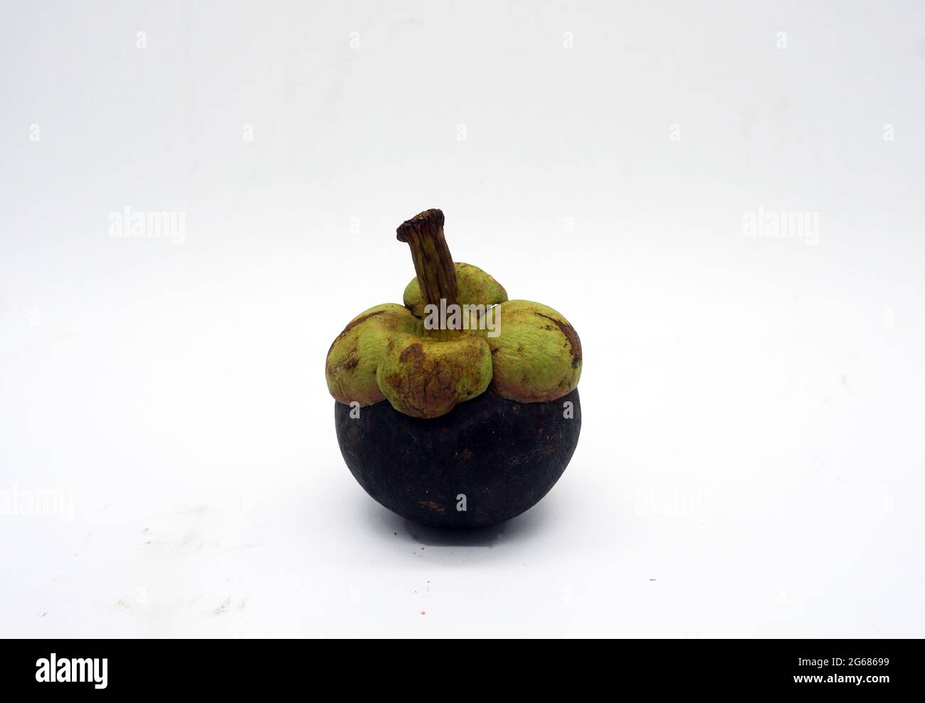 Le mangosteen est un fruit placé sur un fond blanc. Banque D'Images