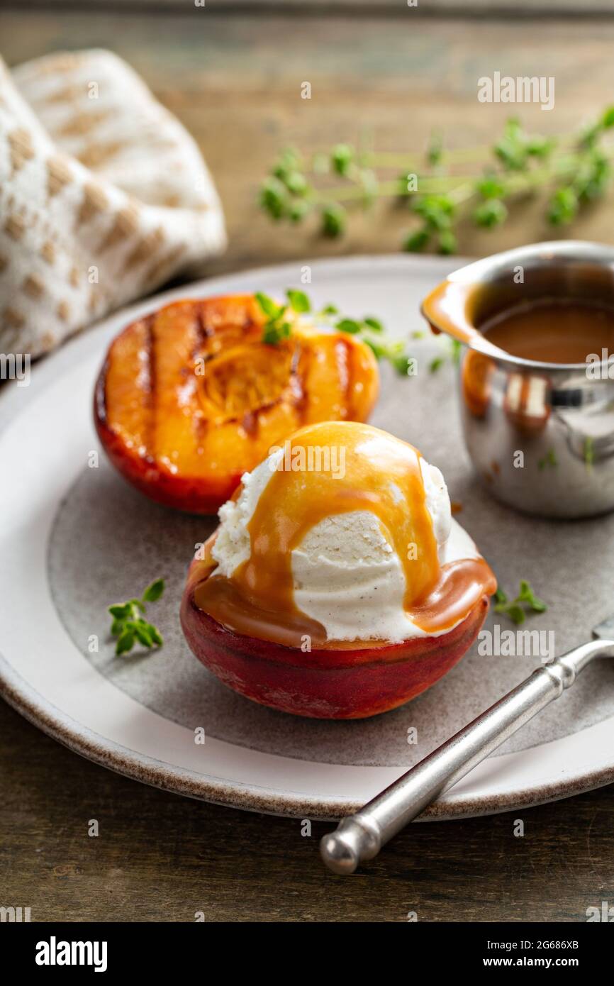 Pêches grillées à la crème glacée et sauce caramel, dessert d'été Banque D'Images