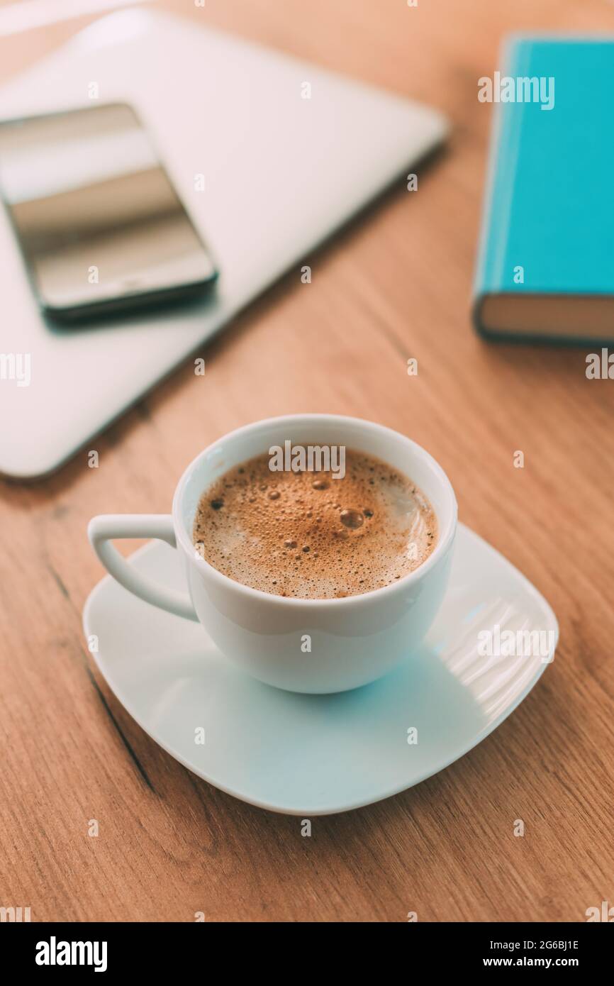 Café du matin avant de commencer le travail indépendant, tasse de café sur bureau à la maison, foyer sélectif Banque D'Images