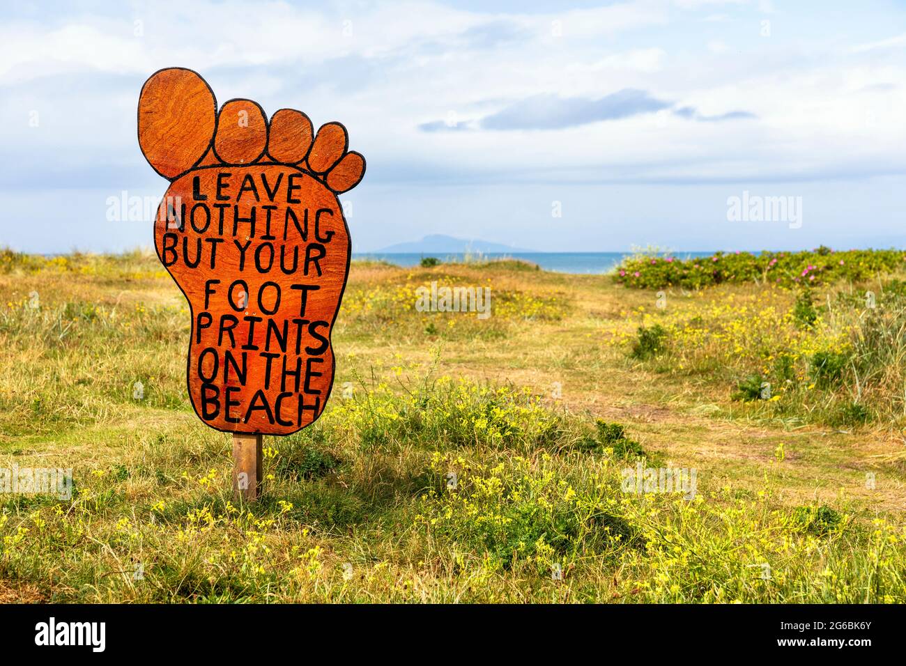 Signe anti pollution en forme de pied, sur le chemin d'accès à la plage publique de Troon, Ayrshire, Écosse, Royaume-Uni Banque D'Images