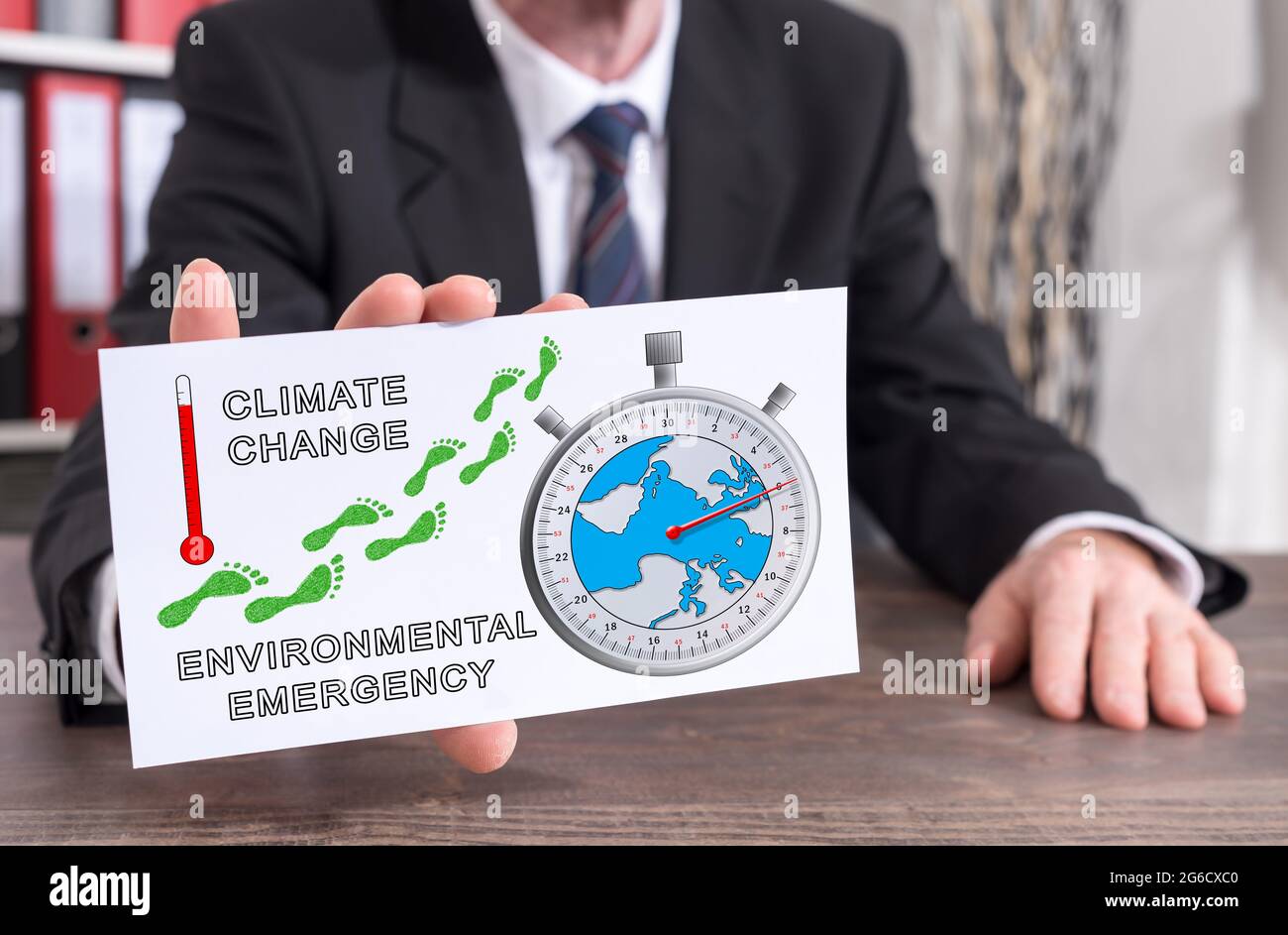 Homme d'affaires montrant un index avec le concept de réchauffement climatique Banque D'Images