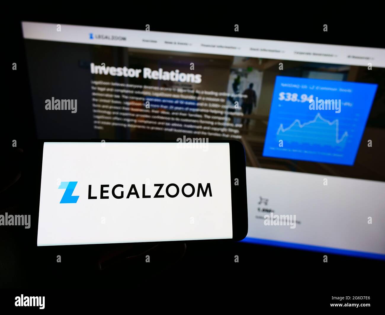 Personne tenant un téléphone portable avec le logo de la société américaine de technologie juridique LegalZoom.com Inc. À l'écran en face de la page Web. Mise au point sur l'affichage du téléphone. Banque D'Images