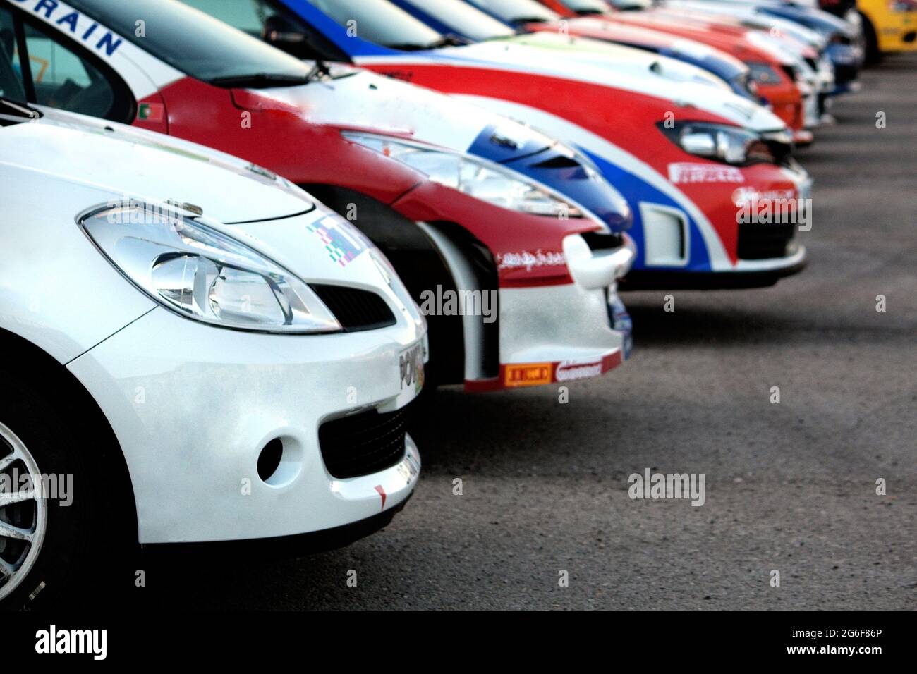 Avis de certaines voitures de rallye colorées alignées sur l'asphalte. Banque D'Images