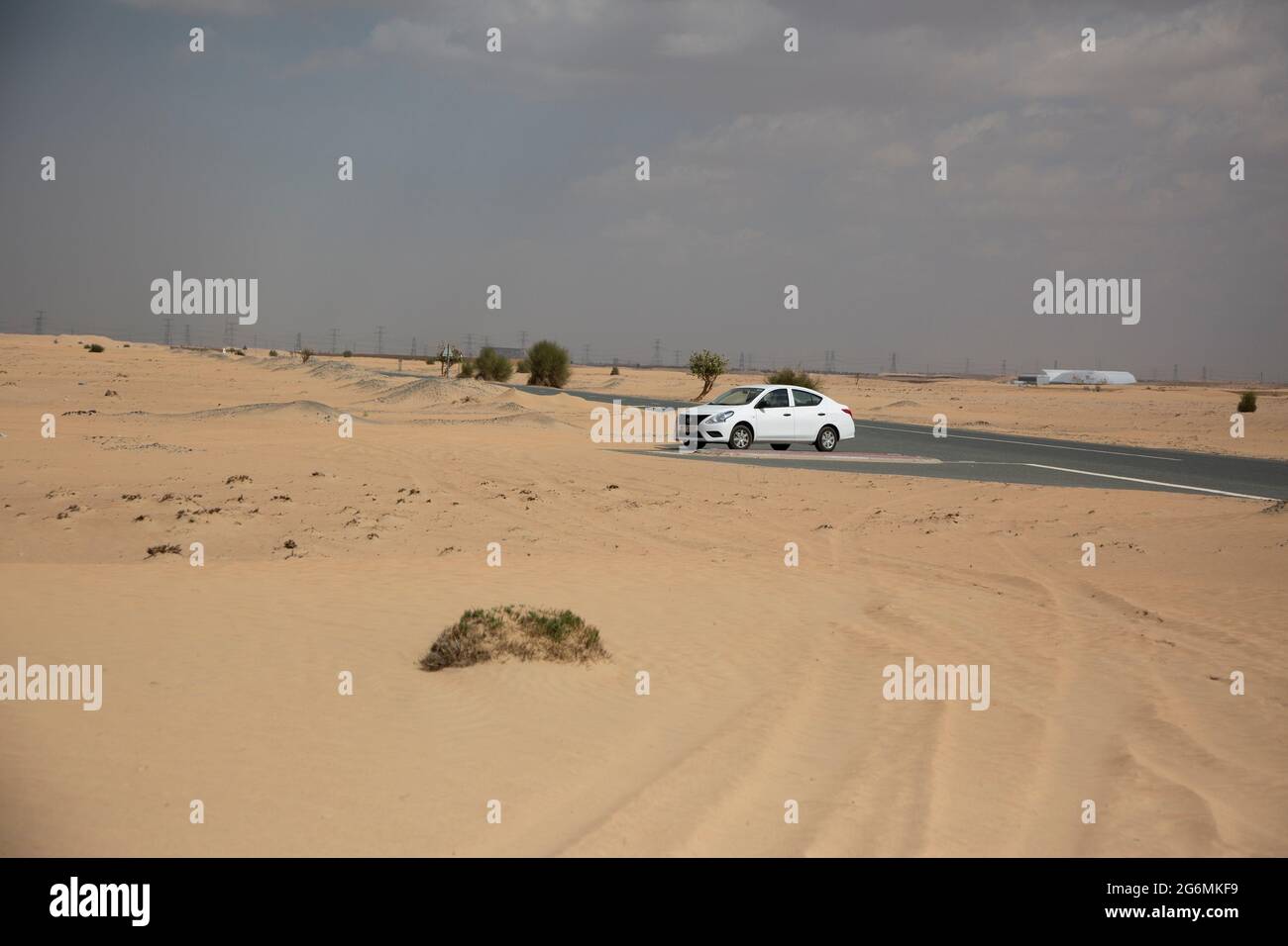 La conduite dans le désert dans un Nissan ensoleillé, Dubaï, Émirats Arabes Unis. Banque D'Images