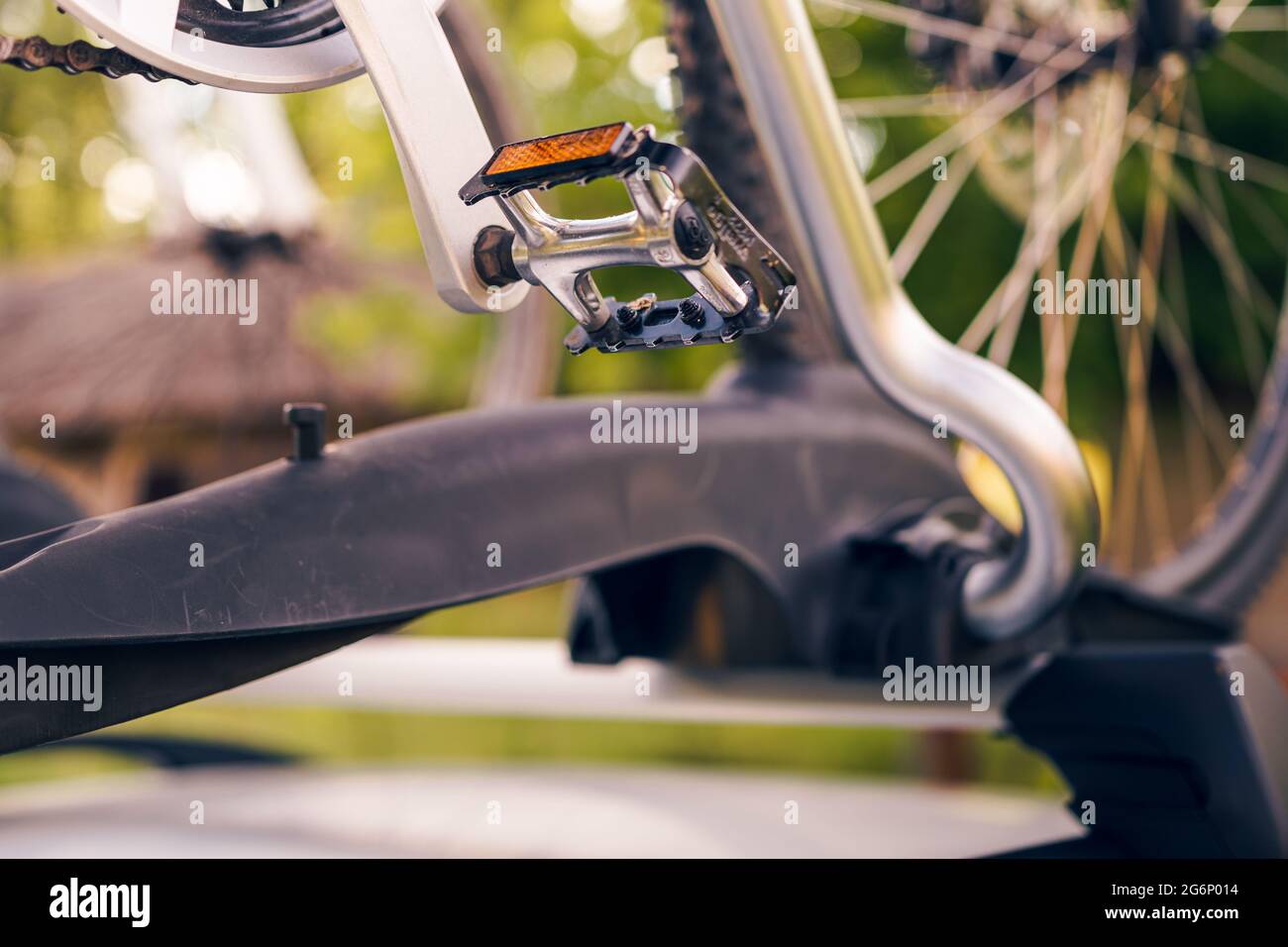 Vélo installé sur le porte-vélo de toit sur une voiture argentée, paysage de campagne en arrière-plan Banque D'Images