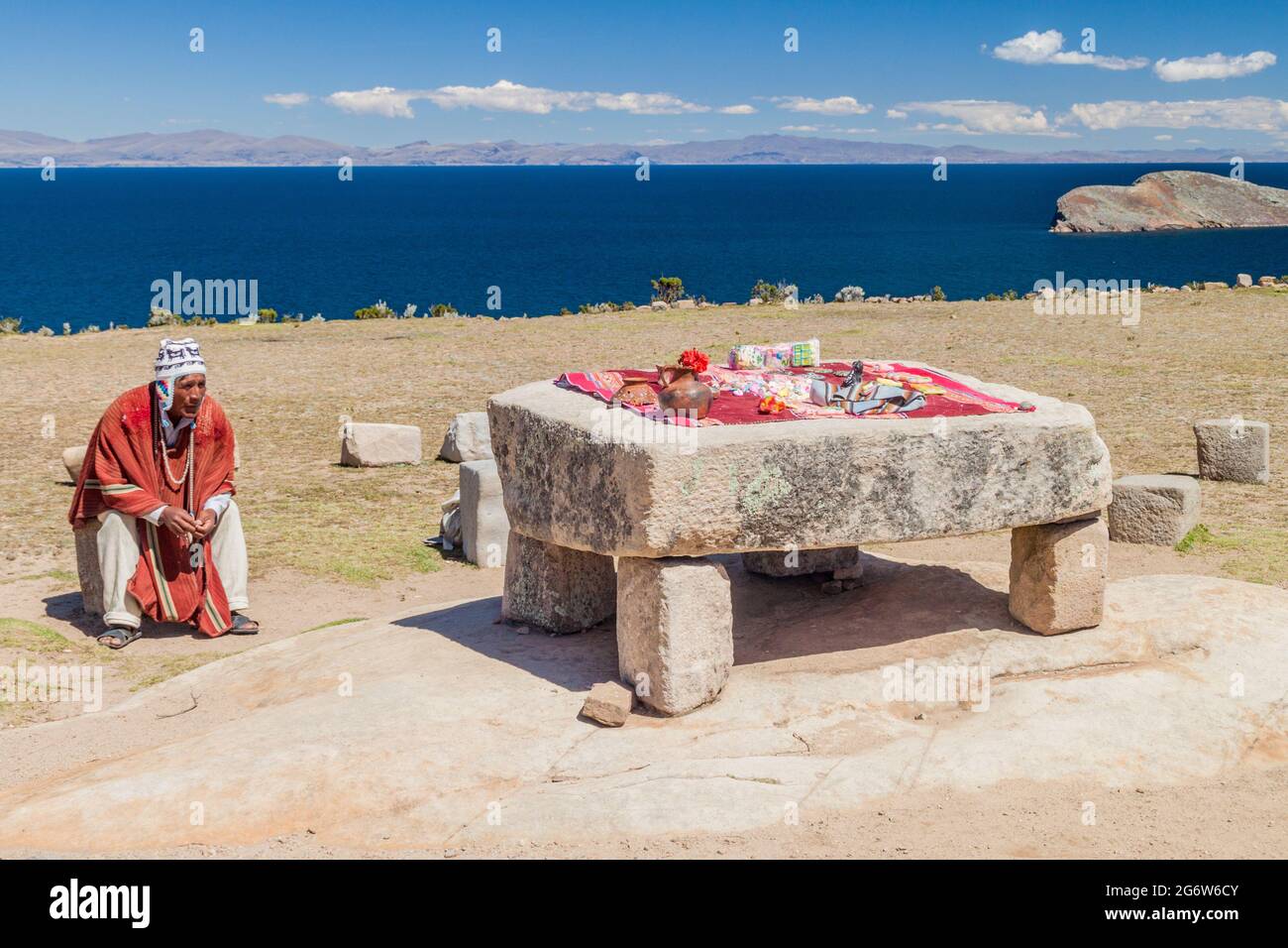 ISLA DEL sol, BOLIVIE - 12 MAI 2015: L'homme natif en vêtements traditionnels près de la table de cérémonie était probablement lieu de sacrifices humains à Banque D'Images