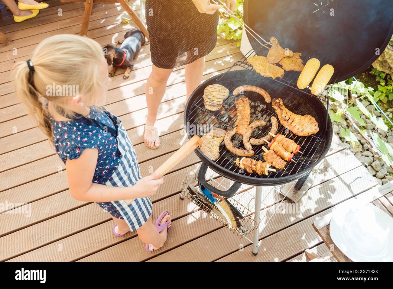 Petite fille la cuisson de la viande pour le barbecue sur un grill Photo  Stock - Alamy