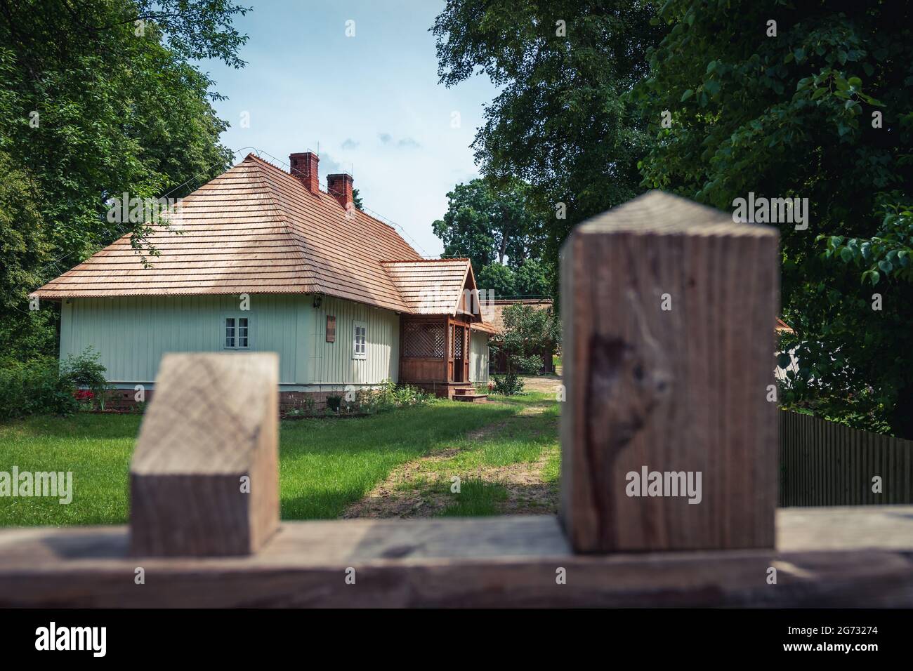 Vieux bâtiments de ferme et une cour entourée d'arbres dans un paysage de campagne lors d'une belle journée ensoleillée de dummer. Zwierzyniec, Roztocze, Pologne. Banque D'Images