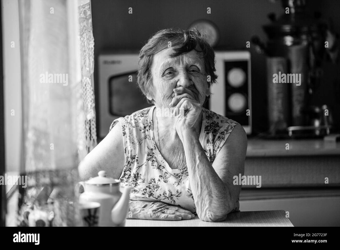 Portrait d'une vieille femme dans sa maison. Photo en noir et blanc. Banque D'Images