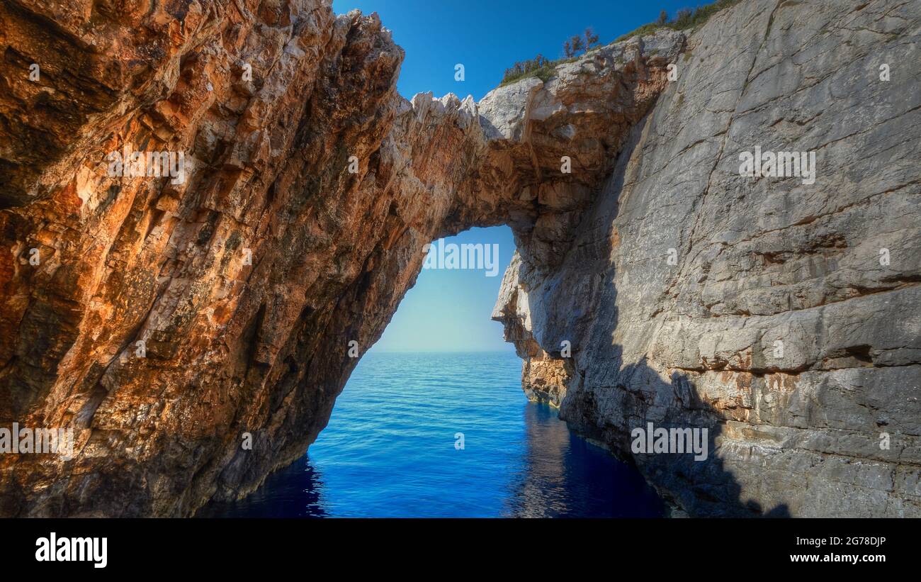 Îles Ioniennes, Zakynthos, côte ouest, Mer Adriatique, Korakonissi, rock island, pont rocheux, sous la mer bleu profond, au-dessus du ciel bleu profond Banque D'Images