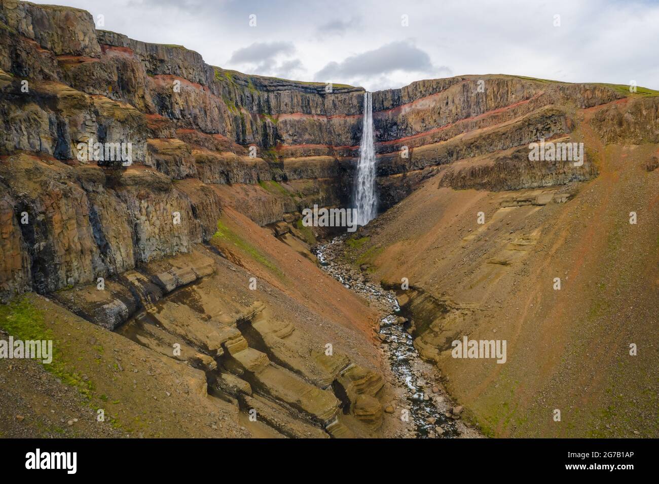 Vue aérienne de la cascade de Hengifoss en Islande orientale. Hengifoss est la troisième plus haute cascade d'Islande et est entourée de strates basaltiques avec des couches rouges d'argile entre les couches basaltiques. Banque D'Images