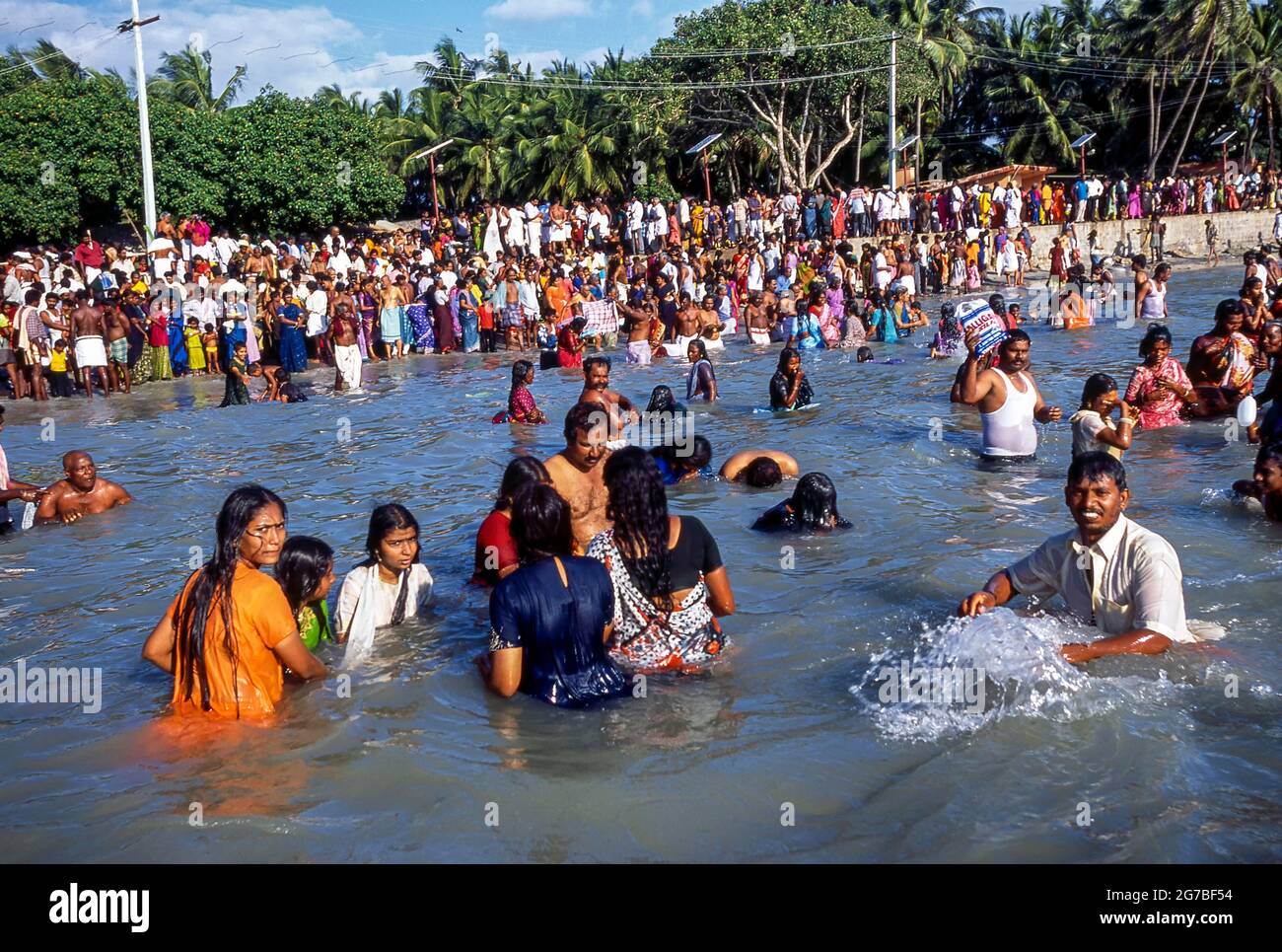 Les dévotés se baignent dans les eaux saintes de l'Agni Theertham le jour de la nouvelle lune; le jour d'Aadi Amavasya à Rameswaram, Tamil Nadu, Inde Banque D'Images