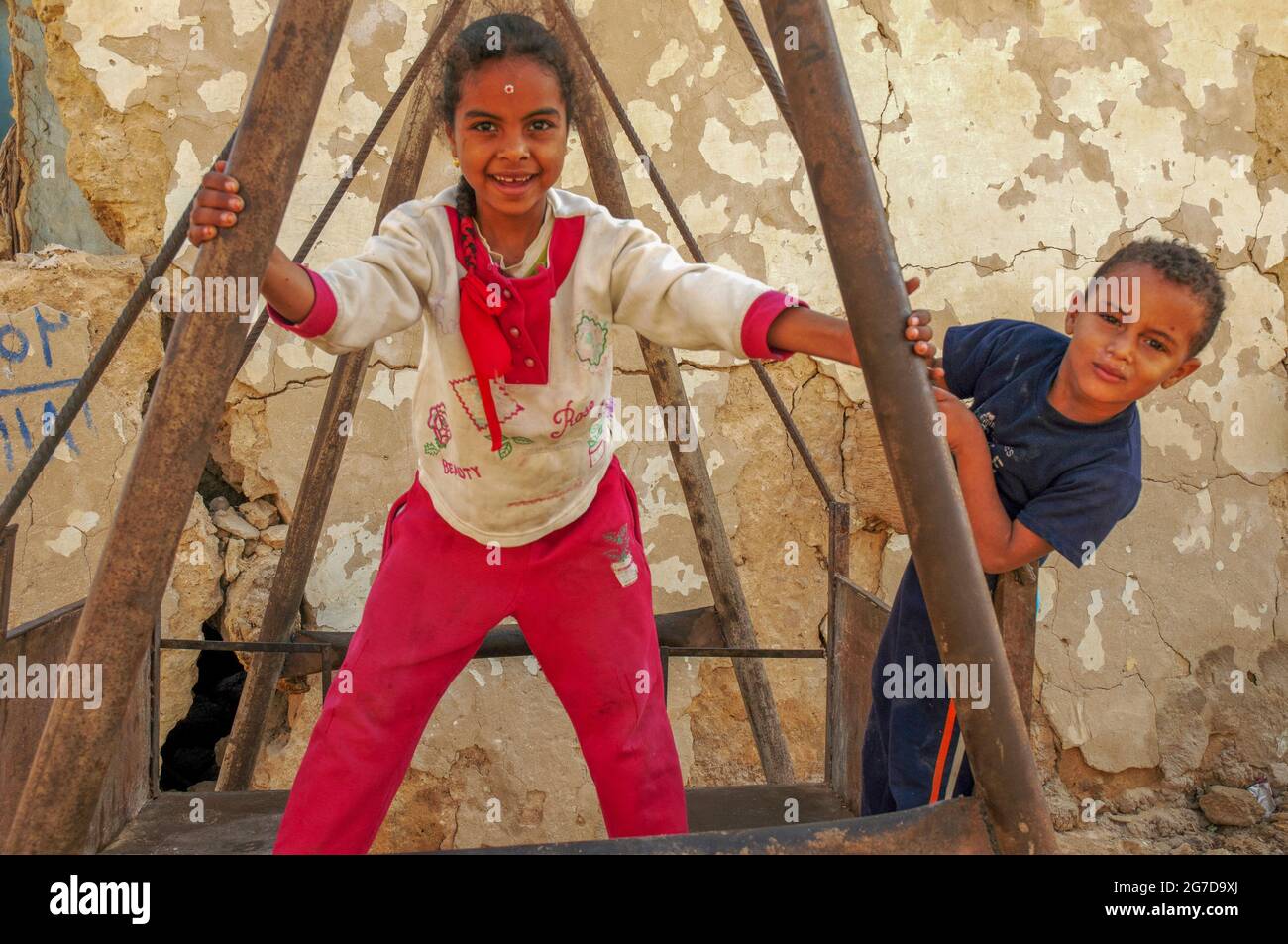 Jeune fille et garçon égyptiens jouant ensemble dans un village de l'Oasis Siwa, une communauté isolée entourée du désert occidental de l'Égypte Banque D'Images
