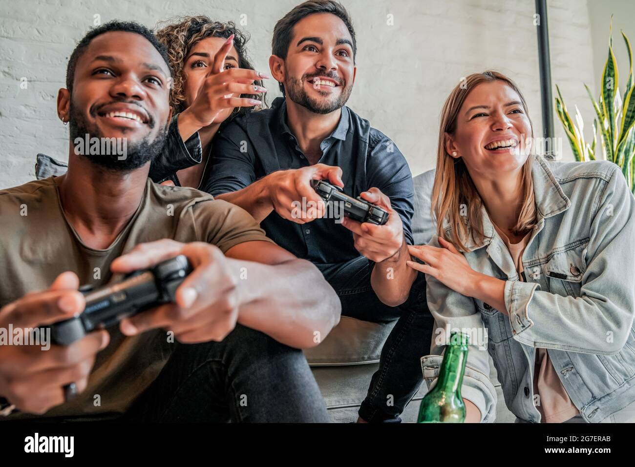 Groupe d'amis jouant à des jeux vidéo ensemble. Banque D'Images