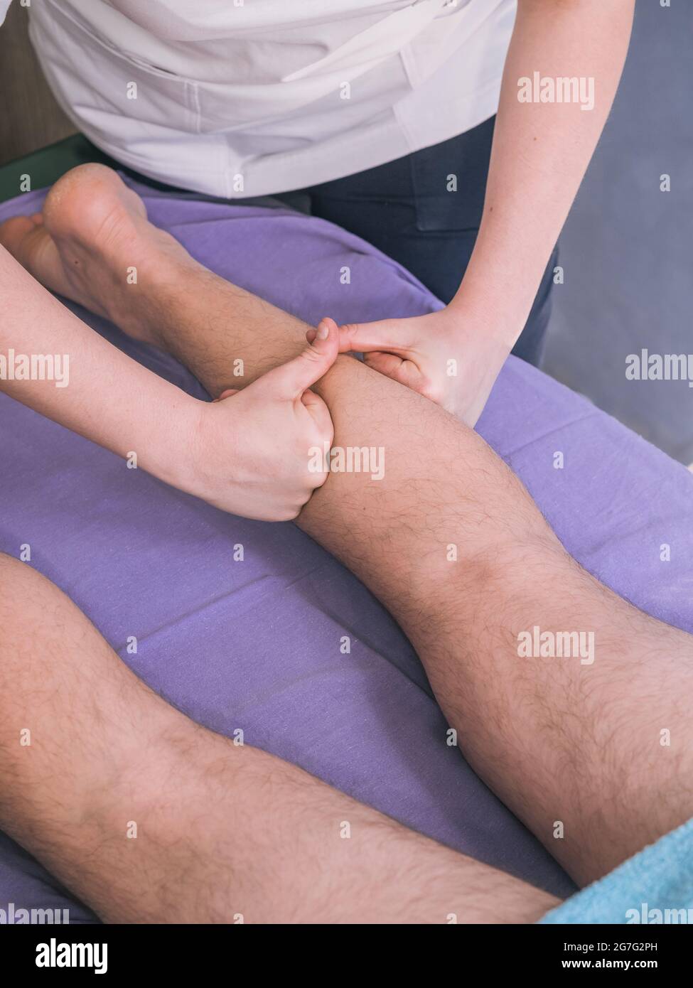 deux personnes, physiothérapeute massant les muscles des jambes de l'homme - veaux. Banque D'Images