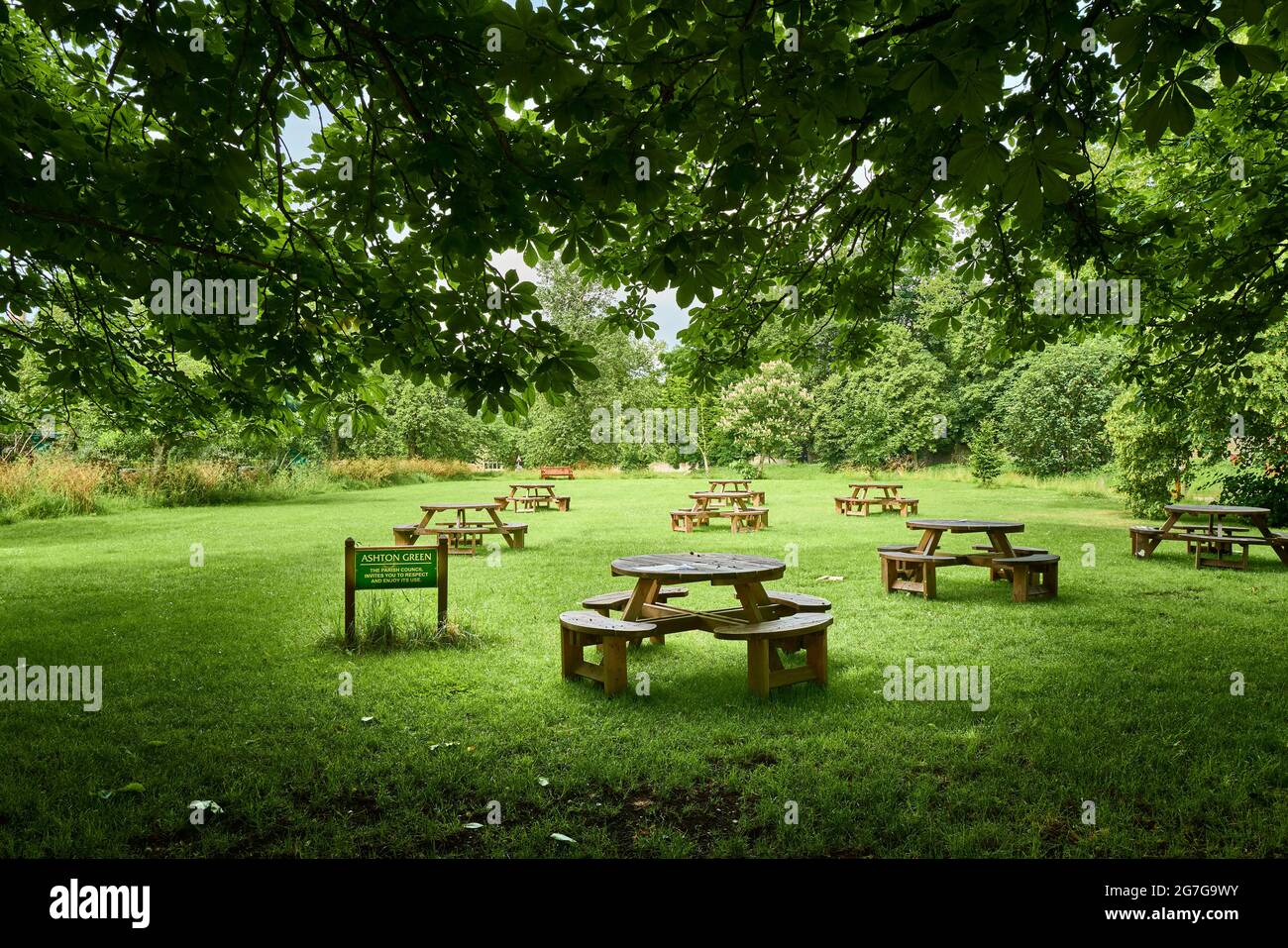Table de pique-nique et chaises socialement distancées sur le village vert à côté du pub dans le village anglais d'Ashton, 2021. Banque D'Images