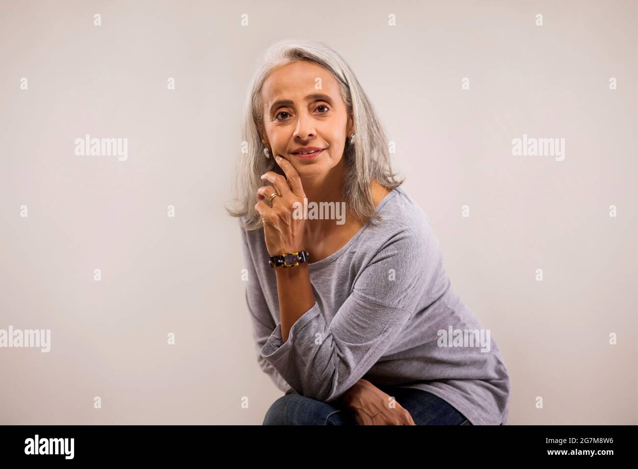Portrait d'une vieille belle femme avec les mains sur son visage. Banque D'Images