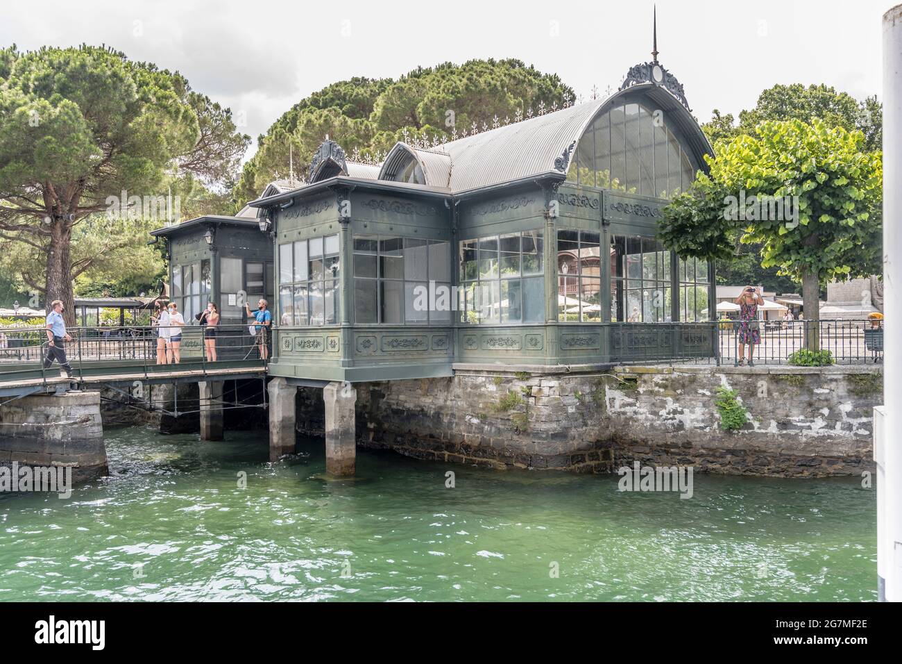 COMO, ITALIE - JUILLET 12: Les touristes attendant à l'arrêt de bateau touristique sur le bord du lac, tourné le 12 juillet 2021 en été à Cernobbio, Côme, Italie Banque D'Images