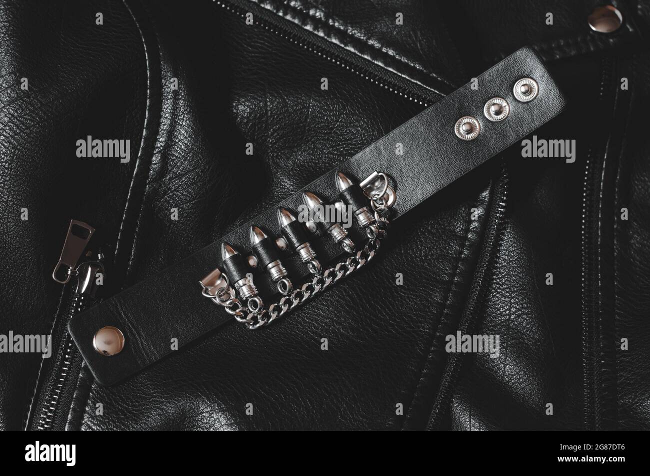 Bracelet en cuir noir avec balles sur une veste en cuir. Banque D'Images