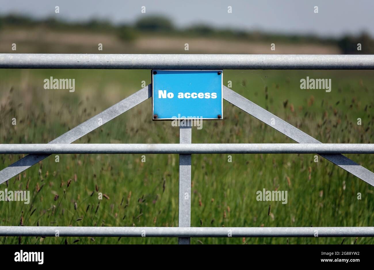 Une clôture en métal gris dans le champ avec un signe bleu avec l'inscription « no Access » Banque D'Images