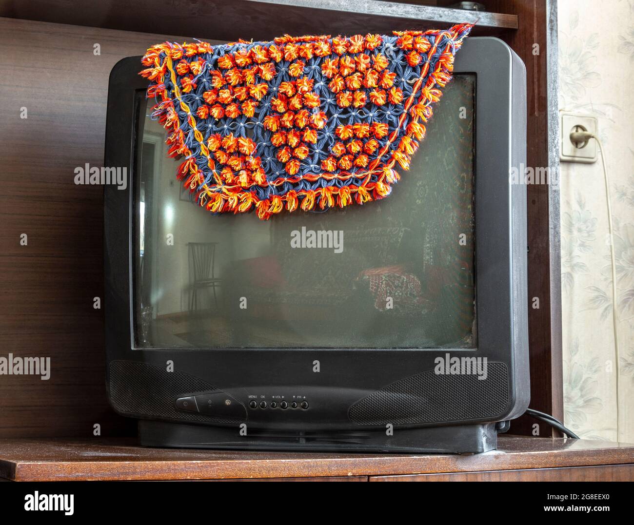 L'ancienne télé tube est couverte d'un cape. Banque D'Images