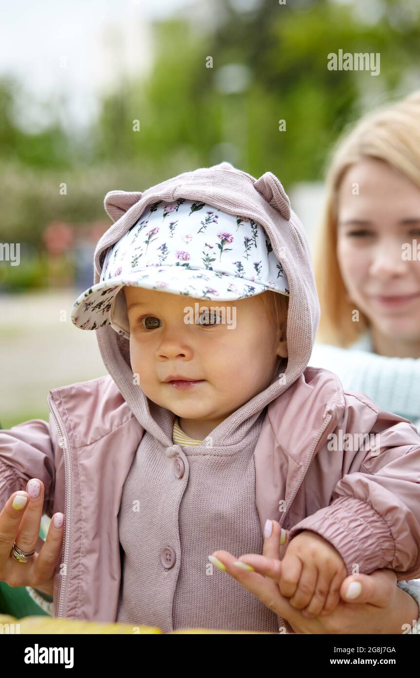 Maman et fille sur l'aire de jeux extérieure. Activité saine pour les enfants. La petite fille et la mère ont un bon moment Banque D'Images