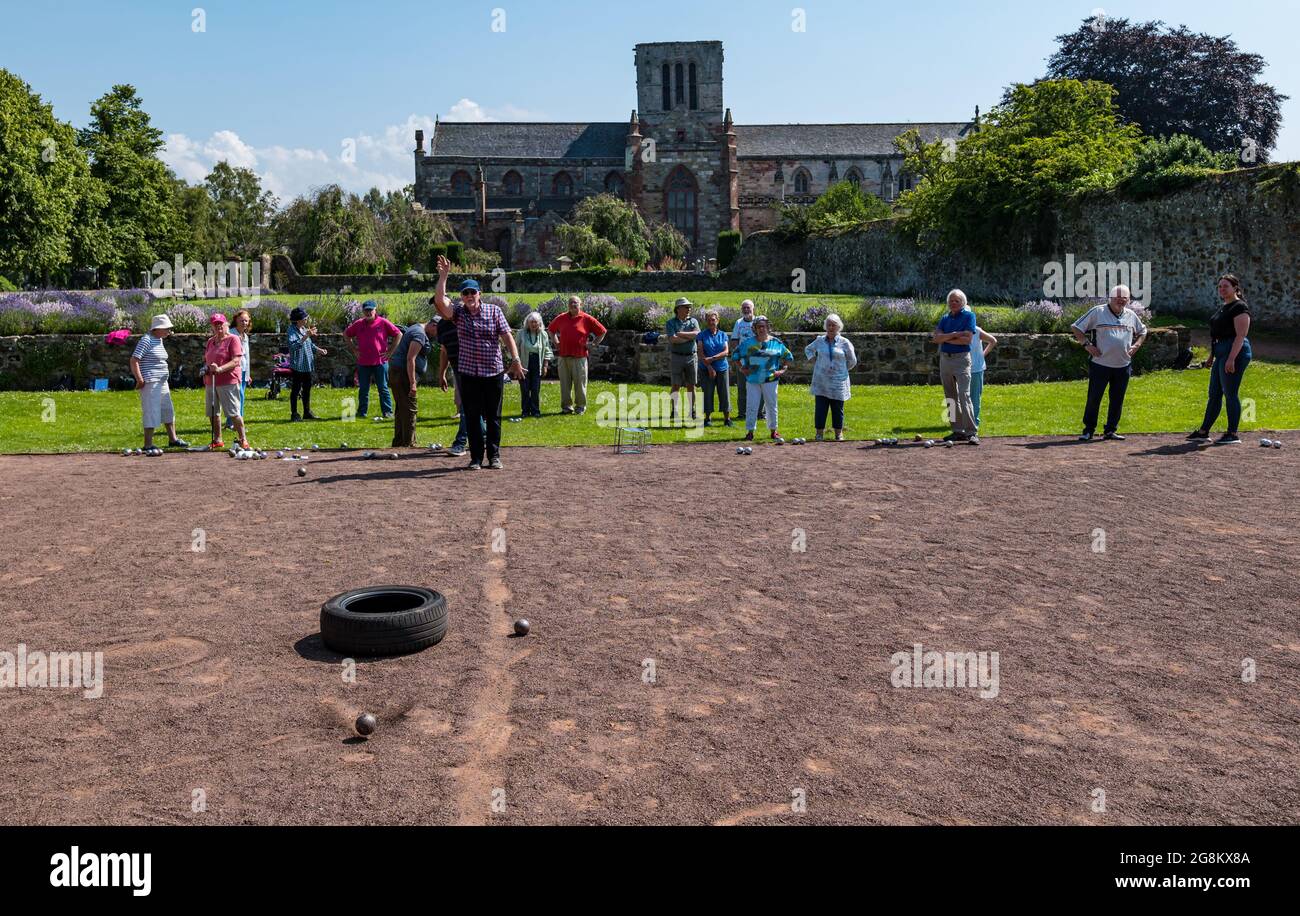 Haddington, East Lothian, Écosse, Royaume-Uni, 21 juillet 2021. U3A séance de coaching Pétanque SPA : Colin (Monty) et Margaret (Maggs) Montgomery, deux entraîneurs SPA (Association écossaise de Pétanque) offrent une leçon au club local de Pétanque de l'Université du 3ème âge, à l'un des jours les plus chauds de l'année dans le cadre pittoresque du jardin de Lady Kitty. La pétanque est une forme de boules, jouées avec des règles légèrement différentes Banque D'Images