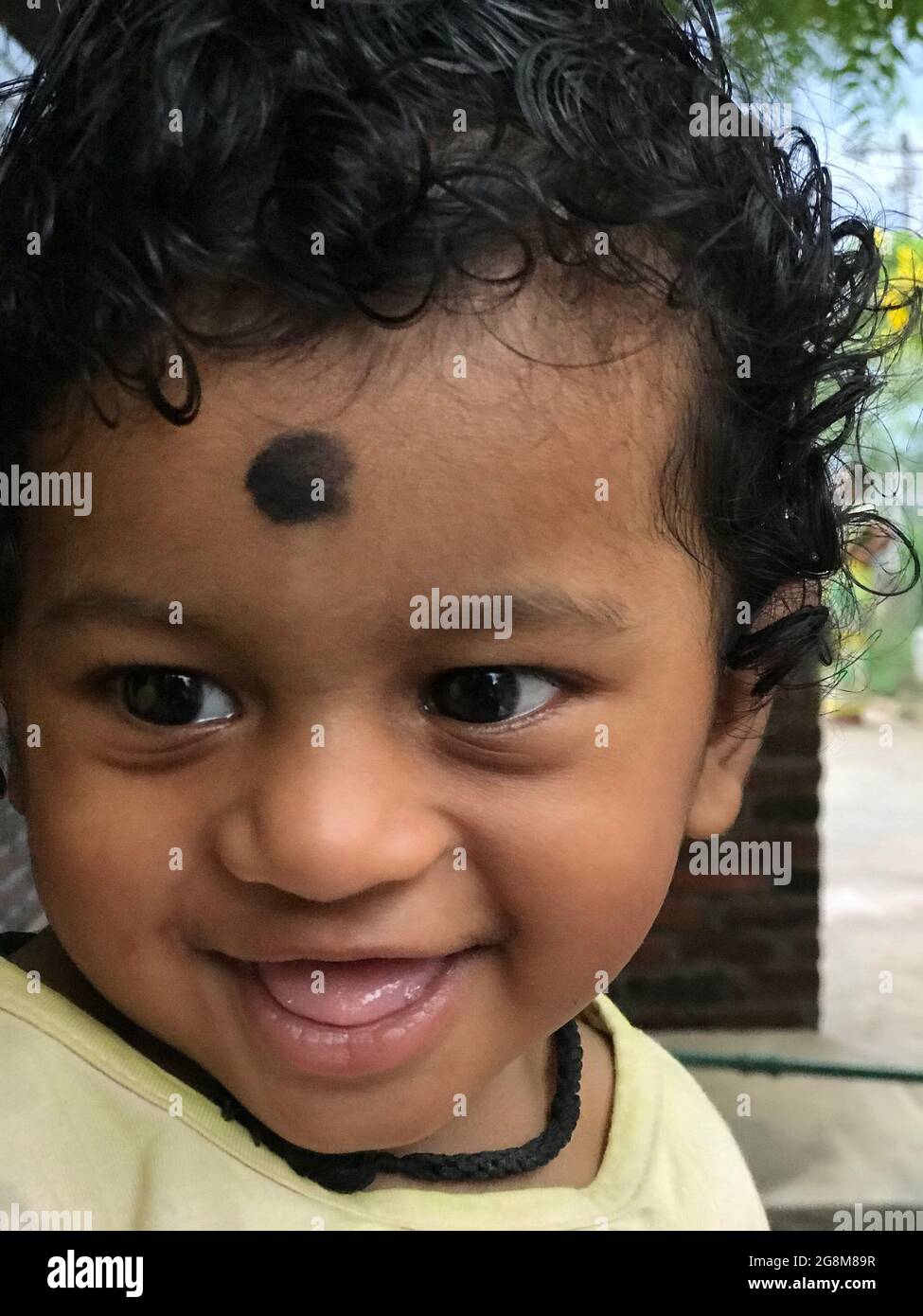 Bébé indien avec des cheveux de curling noirs ou bébé souriant avec rire Banque D'Images