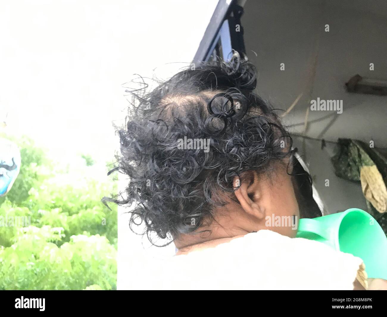 les cheveux se bouchent sur le dos d'une tête d'un bébé indien et sont difficiles à peigner Banque D'Images