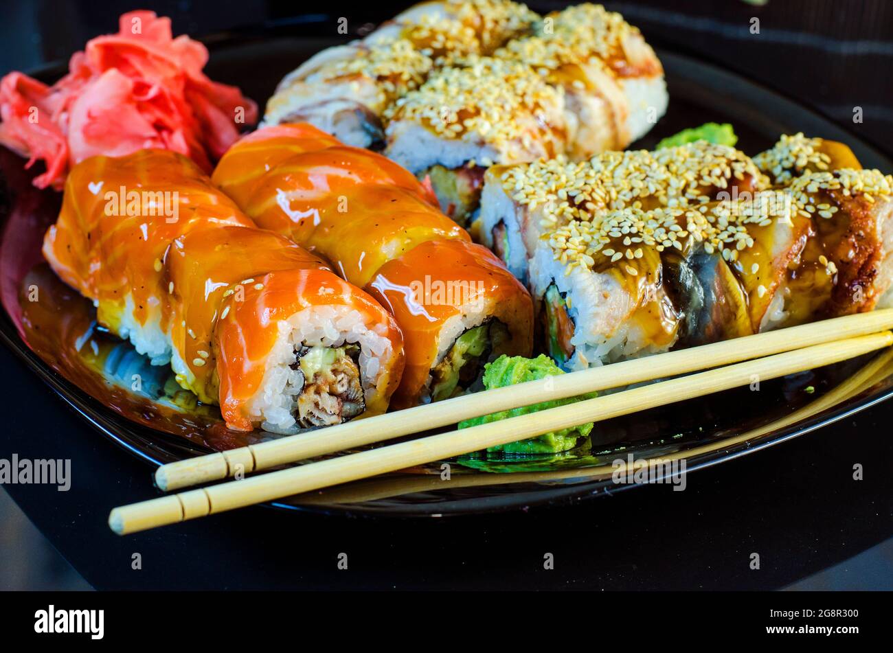 variété de petits pains à sushis sur un bol noir avec baguettes Banque D'Images