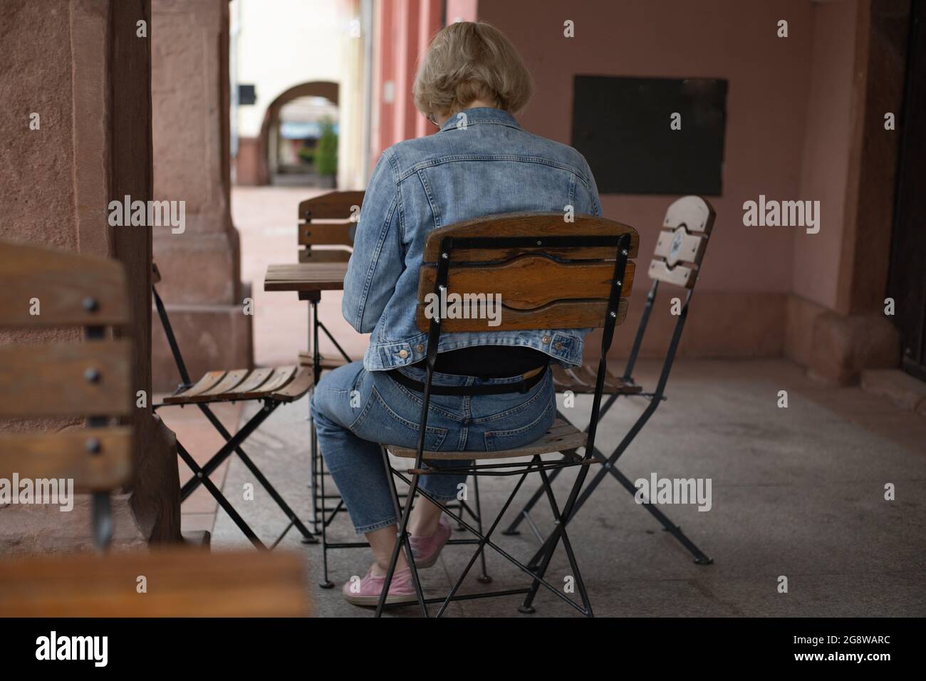 femme assise à une table de café, restaurant en plein air Banque D'Images