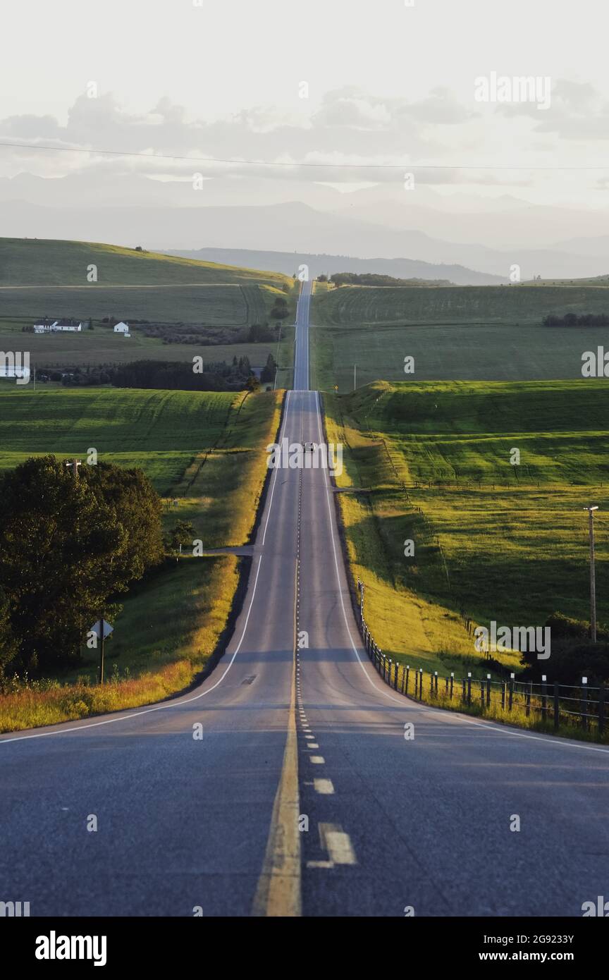 Tout droit, chemin rural pendant le coucher du soleil en Alberta, Canada Banque D'Images