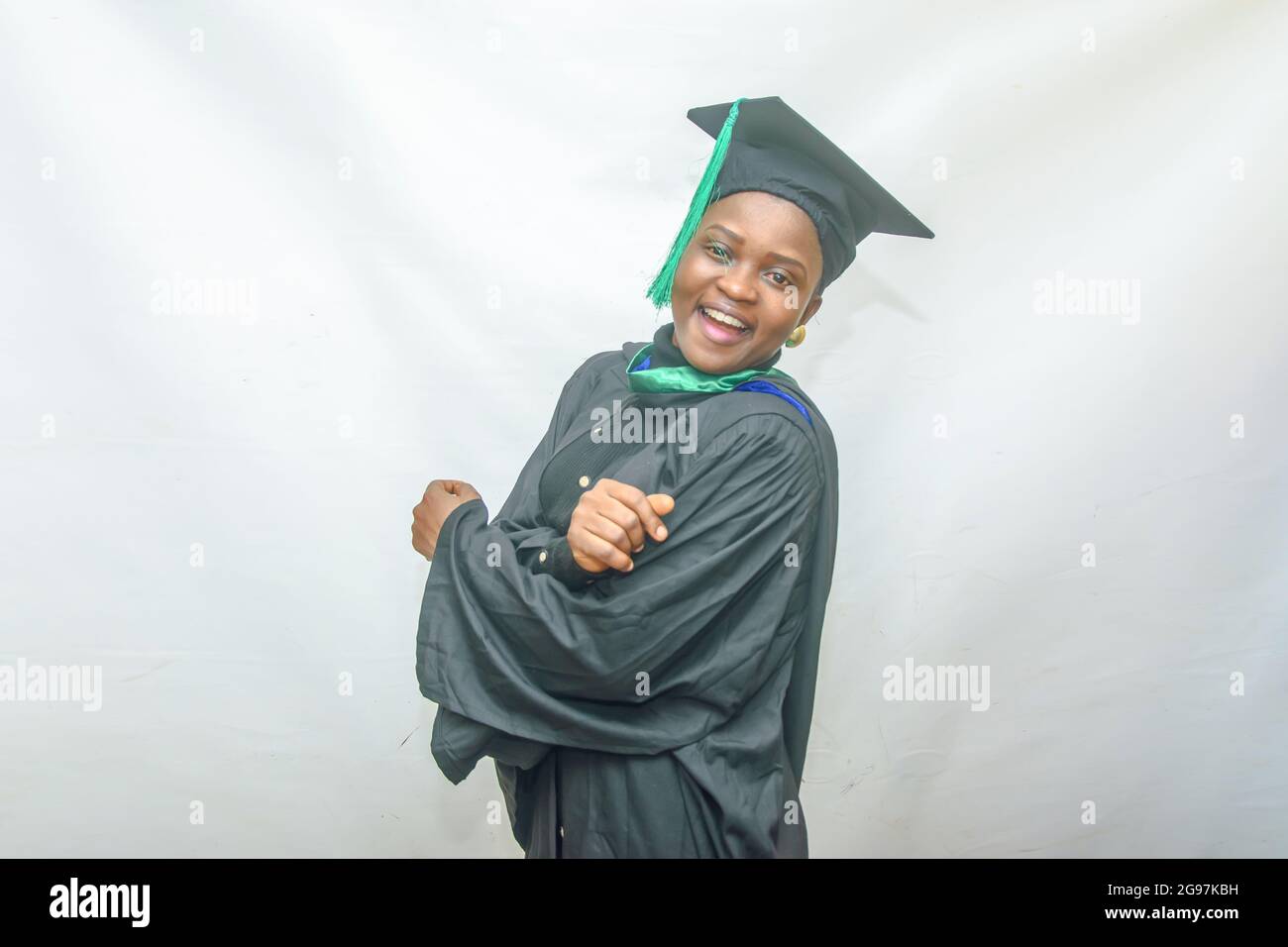 Photo d'une femme africaine finissant ou finissant avec joie son corps dans sa tenue noire de remise des diplômes Banque D'Images