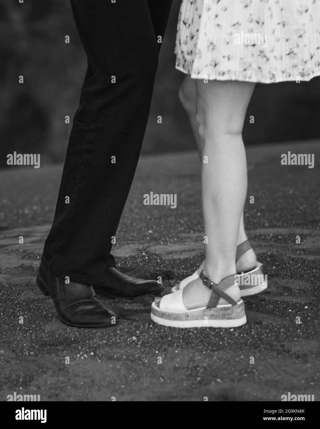 Jambes de jeunes couples dans la rue. Noir et blanc Banque D'Images