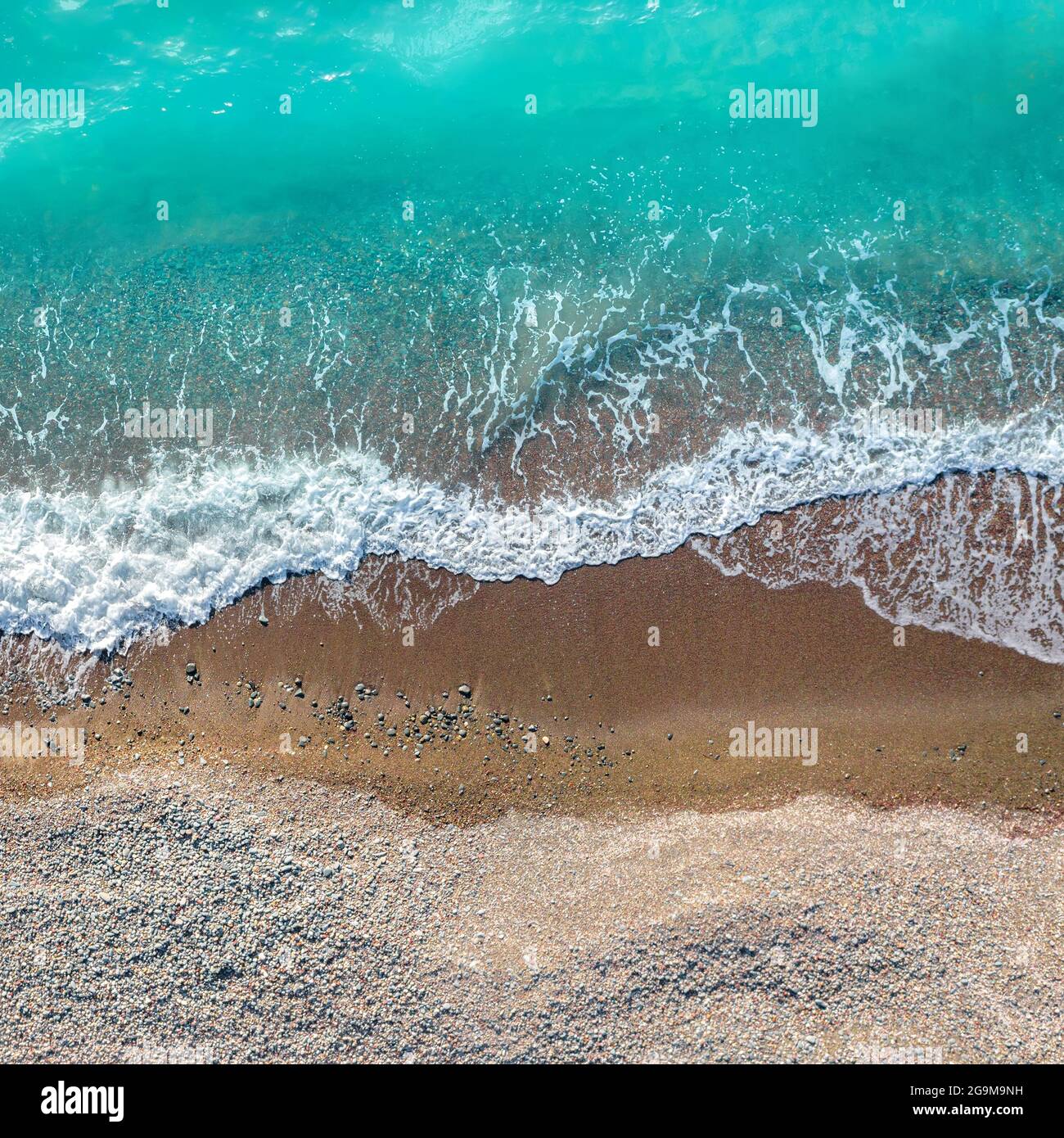 Vagues de la mer sur le sable et la plage de galets, plan carré, vue de dessus directement au-dessus Banque D'Images