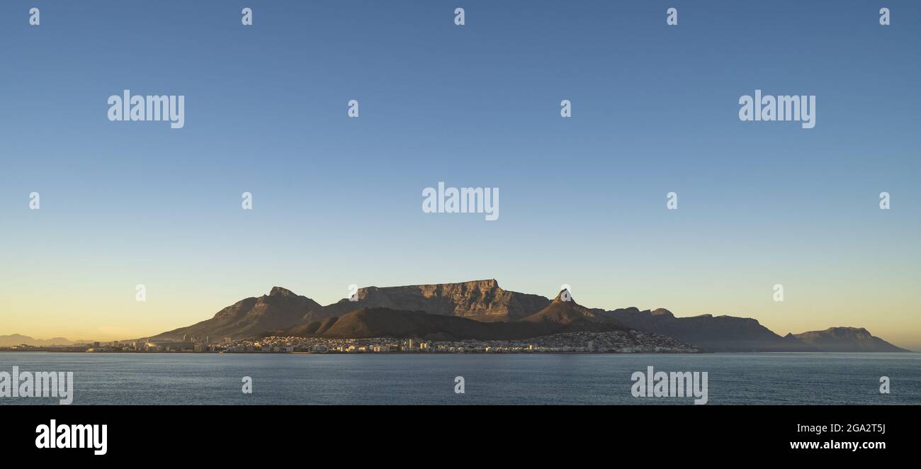 Vue imprenable sur Devil's Peak, Table Mountain et Lion's Head surplombant la ville portuaire de Cape Town à l'aube de la mer Banque D'Images