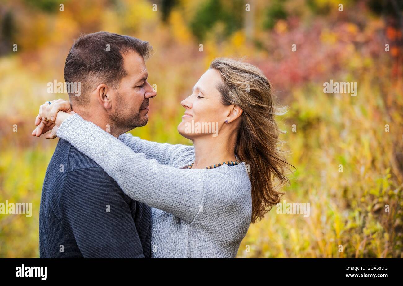 Un couple marié qui passe du temps ensemble de qualité à l'extérieur dans un parc de la ville pendant un après-midi d'automne chaud; St. Albert, Alberta, Canada Banque D'Images